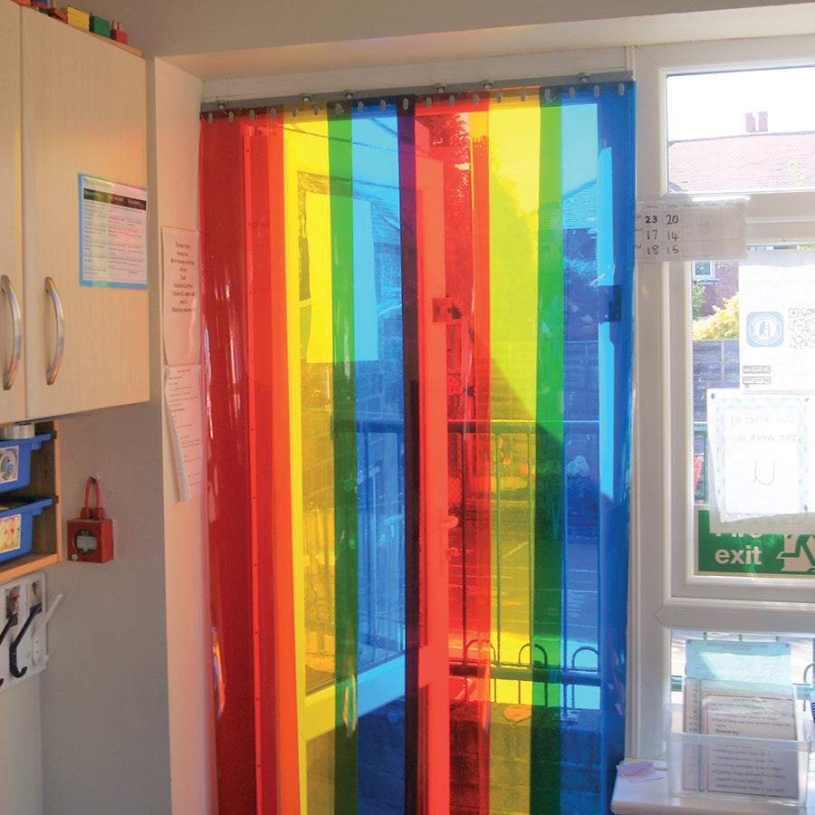 Colorful School Free Flow Curtains in Rainbow Strips installed in a school doorway, enhancing the learning environment with a mix of vibrant translucent colors.