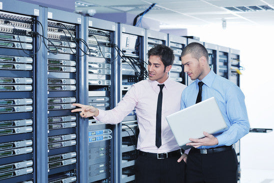 Two IT professionals in a data centre managing servers and IT infrastructure.