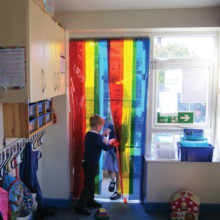 Colorful School Free Flow Curtains in Rainbow Strips installed in a school doorway, enhancing the learning environment with a mix of vibrant translucent colors."